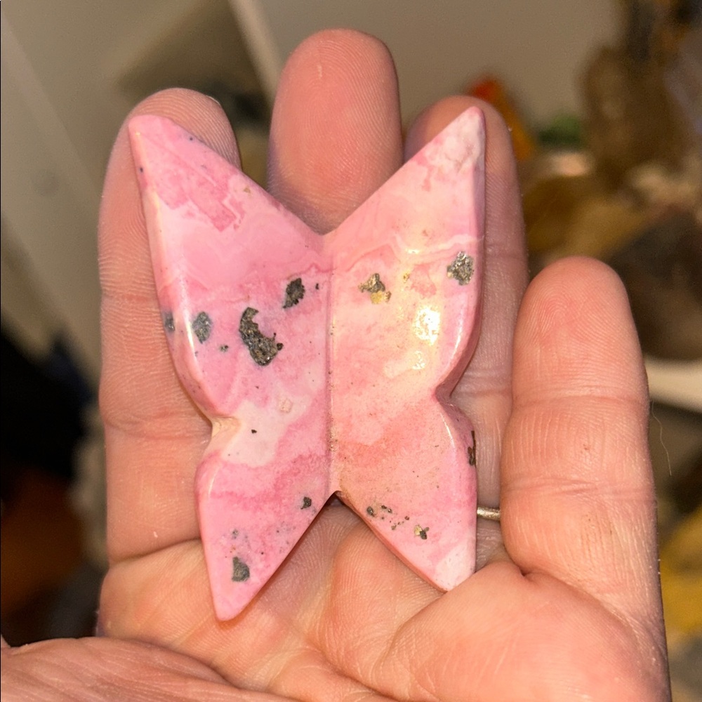 carved butterfly figure made from rhodochrosite crystal.